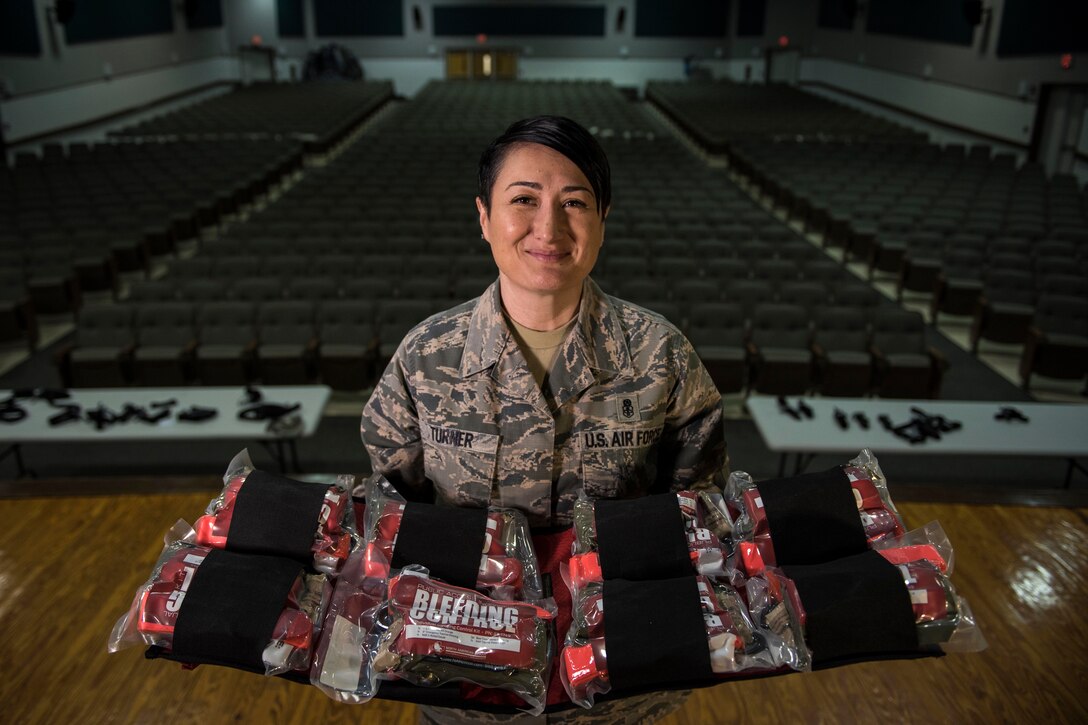 A self-aid buddy care advisor for the U.S. Air Force displays a bleeding kit.