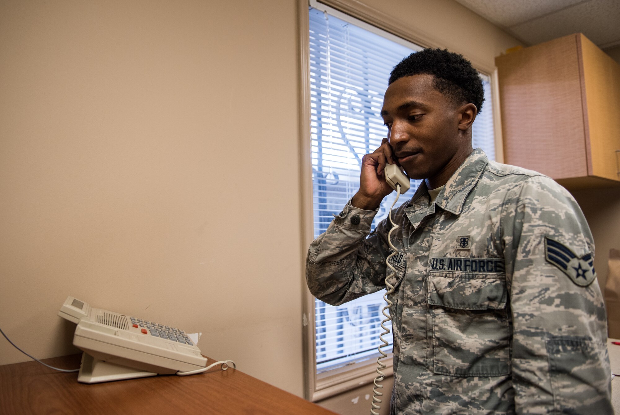 Senior Airman Cole Broomfield, 56th Medical Squadron pharmacy technician, speaks with a patient on the phone July 2, 2018 at the Luke Air Force Base Pharmacy Annex in Scottsdale, Ariz. The Luke AFB Pharmacy Annex, open every Monday and Thursday, provides pharmaceutical services to active duty, retired and veteran service members, as well as their families. (U.S. Air Force photo by Airman 1st Class Alexander Cook)