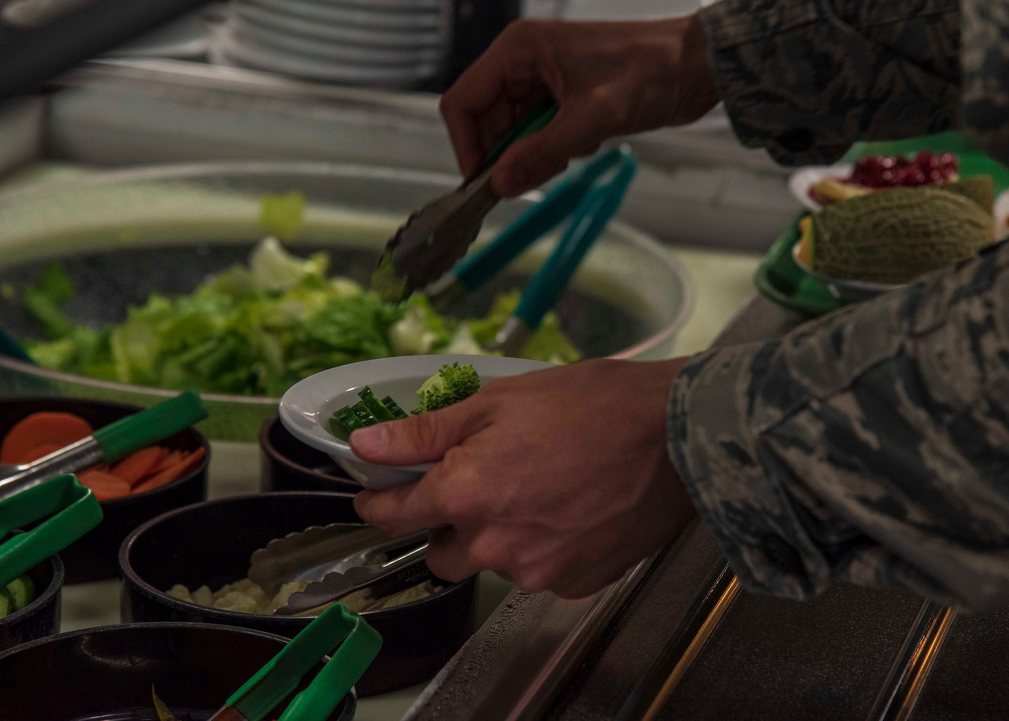 U.S. Air Force Airman 1st Class Brian Vick, a 35th Communication Squadron client system technician, places a piece of broccoli in his bowl at the Grissom Dining Facility at Misawa Air Base, Japan, July 05, 2018. In 2017, the Grissom Dining Facility achieved the highest score for healthy food options on Misawa AB through the Military Nutrition Environment Assessment Tool which assesses the availability of nutritious foods such as vegetables, low fat and low sodium item. (U.S. Air Force photo by Airman 1st Class Collette Brooks)