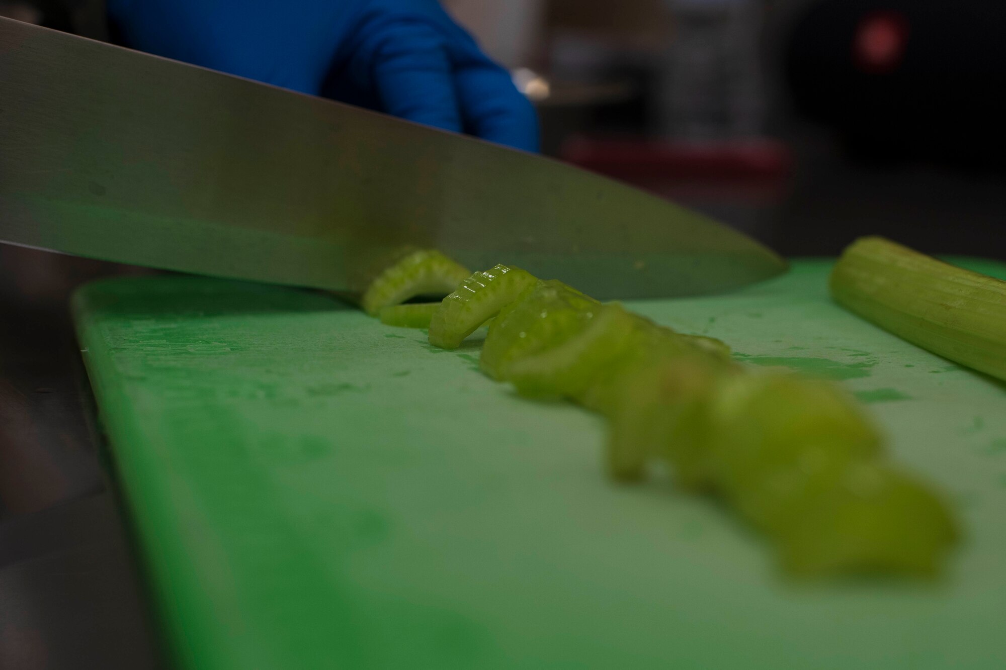 U.S. Air Force Airman 1st Class Kahlil Pollard, a 35th Force Support Squadron food service apprentice, cuts celery with a knife at the Grissom Dining Facility at Misawa Air Base, Japan, July 5, 2018. The facility provides Team Misawa members with a supportive environment in order to enhance healthy eating practices, prevent weight gain and other diseases, allowing individuals to meet mission requirements and maintain fitness for duty. (U.S. Air Force photo by Airman 1st Class Collette Brooks)