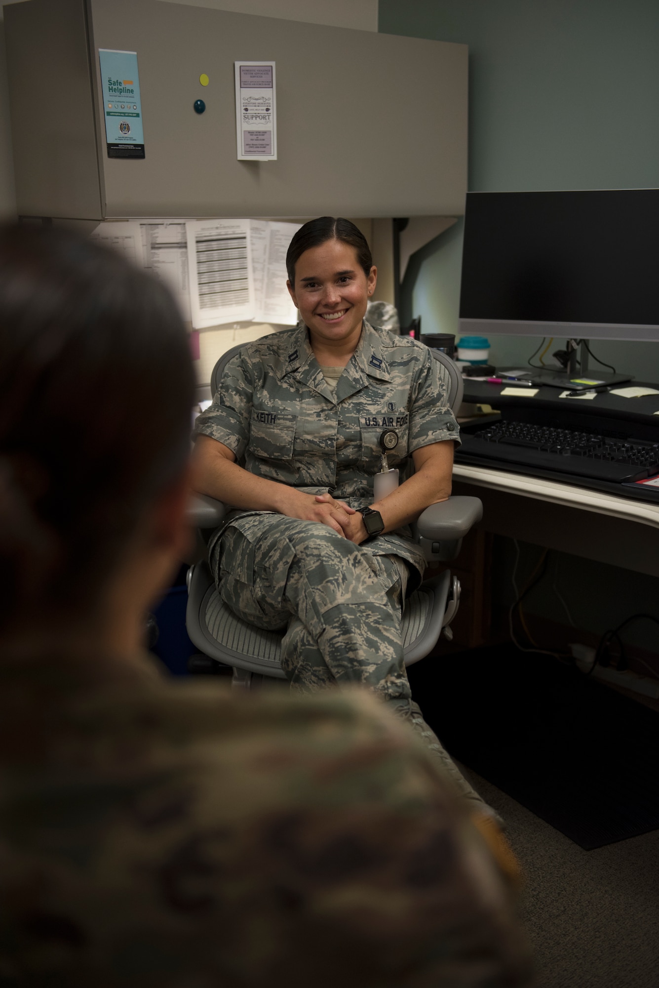 Capt. Felicia Keith, 60th Medical Operations Squadron director of psychological health, listens to one of her patients during a treatment session at David Grant USAF Medical Center at Travis Air Force Base, Calif., June 25, 2018. Keith and her team of professionals have treated more than 200 people who displayed post-traumatic stress symptoms over the past year. Badge blurred for security reasons. (U.S. Air Force photo by Tech. Sgt. James Hodgman)