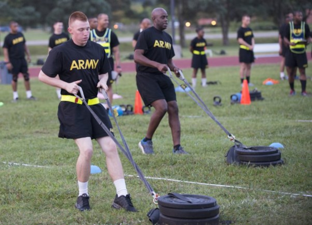 Pfc. Alex Colliver, foreground, pulls a 90-pound sled 50 meters that simulates the strength needed in pulling a battle buddy out of harm's way during a pilot for the Army Combat Fitness Test, a six-event assessment designed to reduce injuries and replace the current Army Physical Fitness Test.