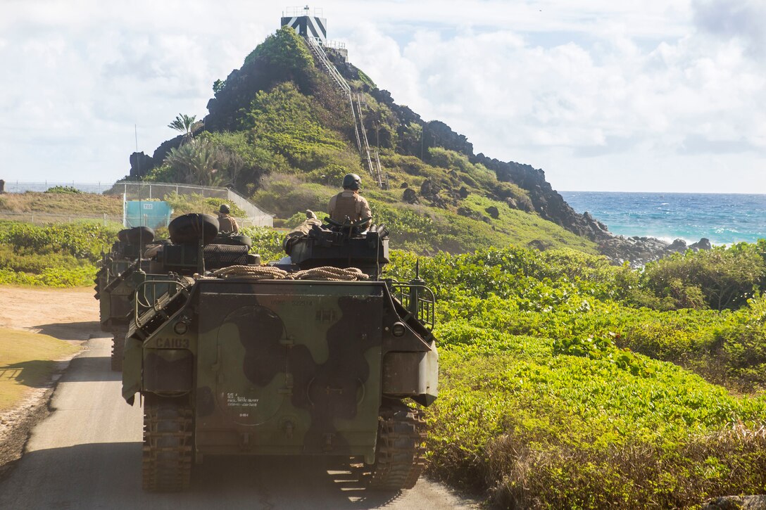 U.S. Marines with Combat Assault Company, 3rd Marine Regiment, make their way to Pyramid Rock Beach in AAV-P7/A1 assault amphibious vehicles prior to splash training as part of Rim of the Pacific (RIMPAC) exercise on Marine Corps Base Hawaii July 8, 2018. RIMPAC provides high-value training for task-organized, highly capable Marine-Air Ground Task Force and enhances the critical crisis response capability of U.S. Marines in the Pacific. Twenty-five nations, 46 ships, five submarines, about 200 aircraft, and 25,000 personnel are participating in RIMPAC from June 27 to Aug. 2 in and around the Hawaiian Islands and Southern California.