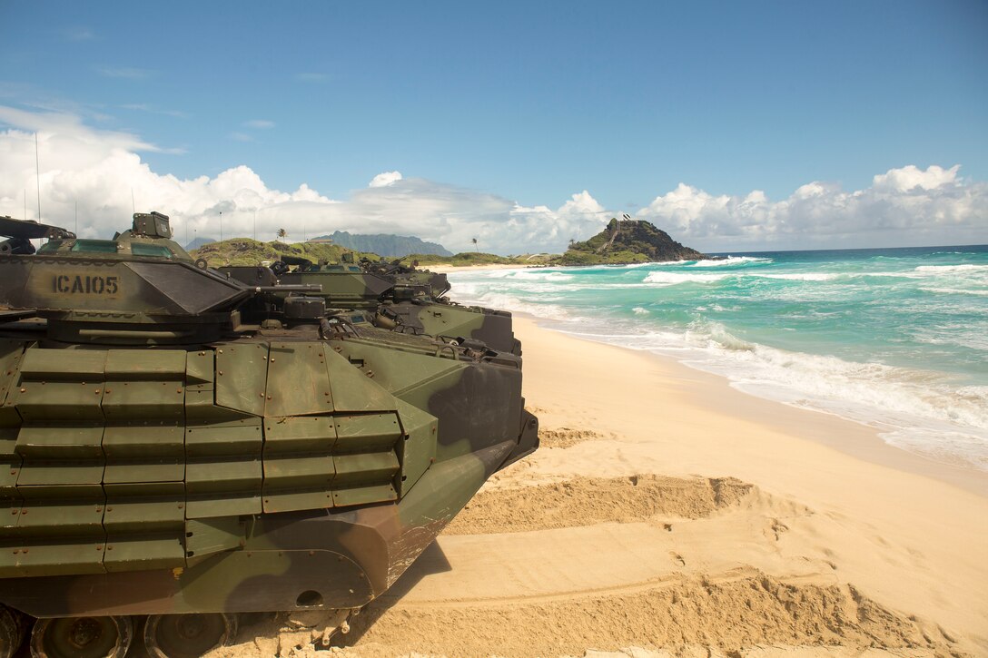 U.S. Marines assigned to Combat Assault Company, 3rd Marine Regiment, stage AAV-P7/A1 amphibious assault vehicles in formation prior to splash training at Pyramid Rock Beach as part of the Rim of the Pacific (RIMPAC) exercise on Marine Corps Base Hawaii July 8, 2018. RIMPAC provides high-value training for task-organized, highly capable Marine-Air Ground Task Force and enhances the critical crisis response capability of U.S. Marines in the Pacific. Twenty-five nations, 46 ships, five submarines, about 200 aircraft, and 25,000 personnel are participating in RIMPAC from June 27 to Aug. 2 in and around the Hawaiian Islands and Southern California.