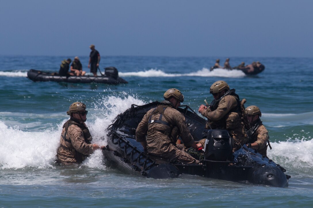 U.S. Marines with 1st Marine Reconnaissance Battalion and Canadian soldiers with the Royal 22e Régiment re-enter a combat rubber raiding craft during Rim of the Pacific (RIMPAC) exercise at Marine Corps Base Camp Pendleton, California, July 8, 2018. RIMPAC demonstrates the value of amphibious forces and provides high-value training for task-organized, highly capable Marine Air-Ground Task Forces enhancing the critical crisis response capability of U.S. forces and partners globally. Twenty-five nations, 46 ships, five submarines, about 200 aircraft and 25,000 personnel are participating in RIMPAC from June 27 to Aug. 2 in and around the Hawaiian Islands and Southern California.