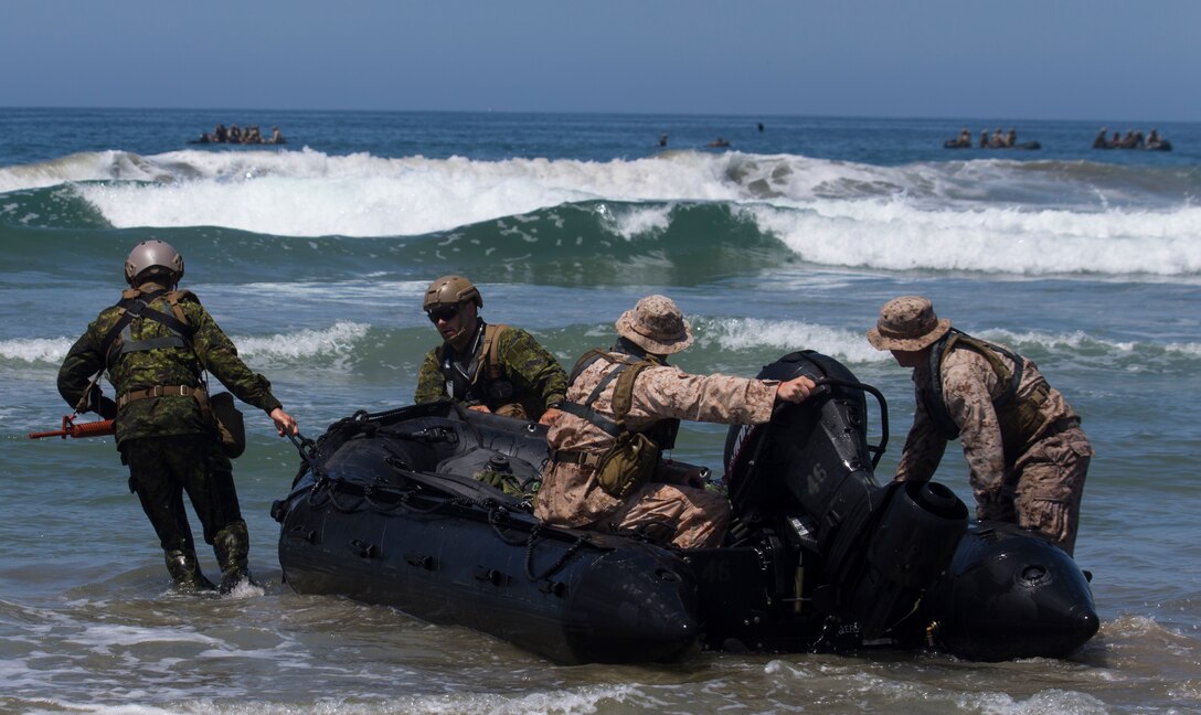 U.S. Marines with 1st Marine Reconnaissance Battalion and Canadian soldiers with the Royal 22e Régiment re-enter a combat rubber raiding craft during Rim of the Pacific (RIMPAC) exercise at Marine Corps Base Camp Pendleton, California, July 8, 2018. RIMPAC demonstrates the value of amphibious forces and provides high-value training for task-organized, highly capable Marine Air-Ground Task Forces enhancing the critical crisis response capability of U.S. forces and partners globally. Twenty-five nations, 46 ships, five submarines, about 200 aircraft and 25,000 personnel are participating in RIMPAC from June 27 to Aug. 2 in and around the Hawaiian Islands and Southern California.