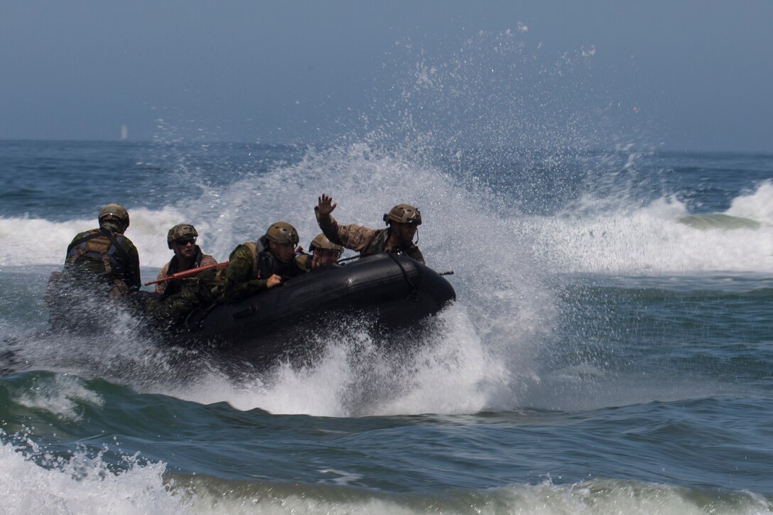 U.S. Marines with 1st Marine Reconnaissance Battalion and Canadian soldiers with the Royal 22e Régiment advance to shore during Rim of the Pacific (RIMPAC) exercise at Marine Corps Base Camp Pendleton, California, July 8, 2018. RIMPAC demonstrates the value of amphibious forces and provides high-value training for task-organized, highly capable Marine Air-Ground Task Forces enhancing the critical crisis response capability of U.S. forces and partners globally. Twenty-five nations, 46 ships, five submarines, about 200 aircraft and 25,000 personnel are participating in RIMPAC from June 27 to Aug. 2 in and around the Hawaiian Islands and Southern California.