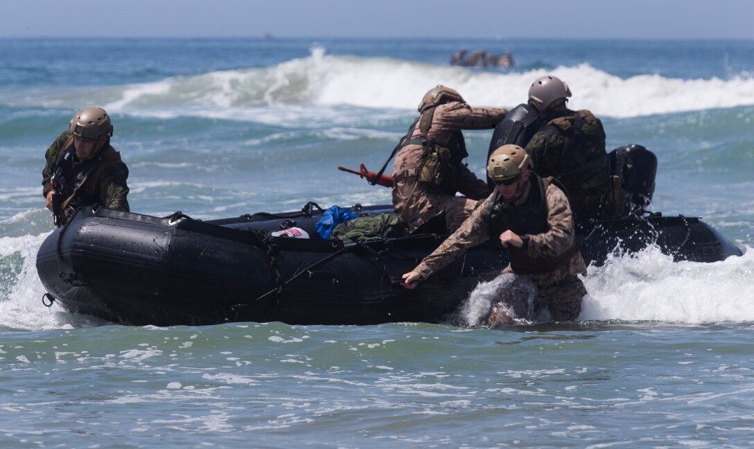 U.S. Marines with 1st Marine Reconnaissance Battalion and Canadian soldiers with the Royal 22e Régiment dismount a combat rubber raiding craft during Rim of the Pacific (RIMPAC) exercise at Marine Corps Base Camp Pendleton, California, July 8, 2018. RIMPAC demonstrates the value of amphibious forces and provides high-value training for task-organized, highly capable Marine Air-Ground Task Forces enhancing the critical crisis response capability of U.S. forces and partners globally. Twenty-five nations, 46 ships, five submarines, about 200 aircraft and 25,000 personnel are participating in RIMPAC from June 27 to Aug. 2 in and around the Hawaiian Islands and Southern California.