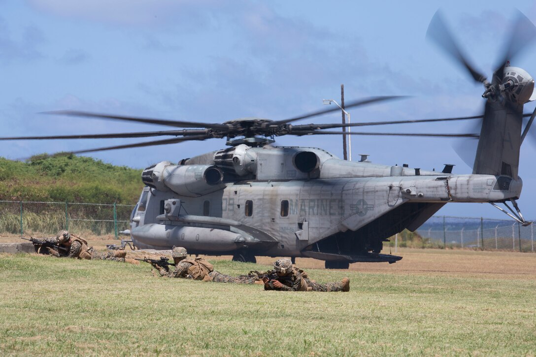 U.S. Marines with Company A, 1st Battalion, 3rd Marine Regiment, post security around a CH-53E Super Stallion helicopter during an air-assault rehearsal as part of Rim of the Pacific (RIMPAC) exercise on Marine Corps Base Hawaii July 6, 2018. RIMPAC provides high-value training for task-organized, highly-capable Marine Air-Ground Task Force and enhances the critical crisis response capability of U.S. Marines in the Pacific. Twenty-five nations, 46 ships, five submarines, about 200 aircraft and 25,000 personnel are participating in RIMPAC from June 27 to Aug. 2 in and around the Hawaiian Islands and Southern California.
