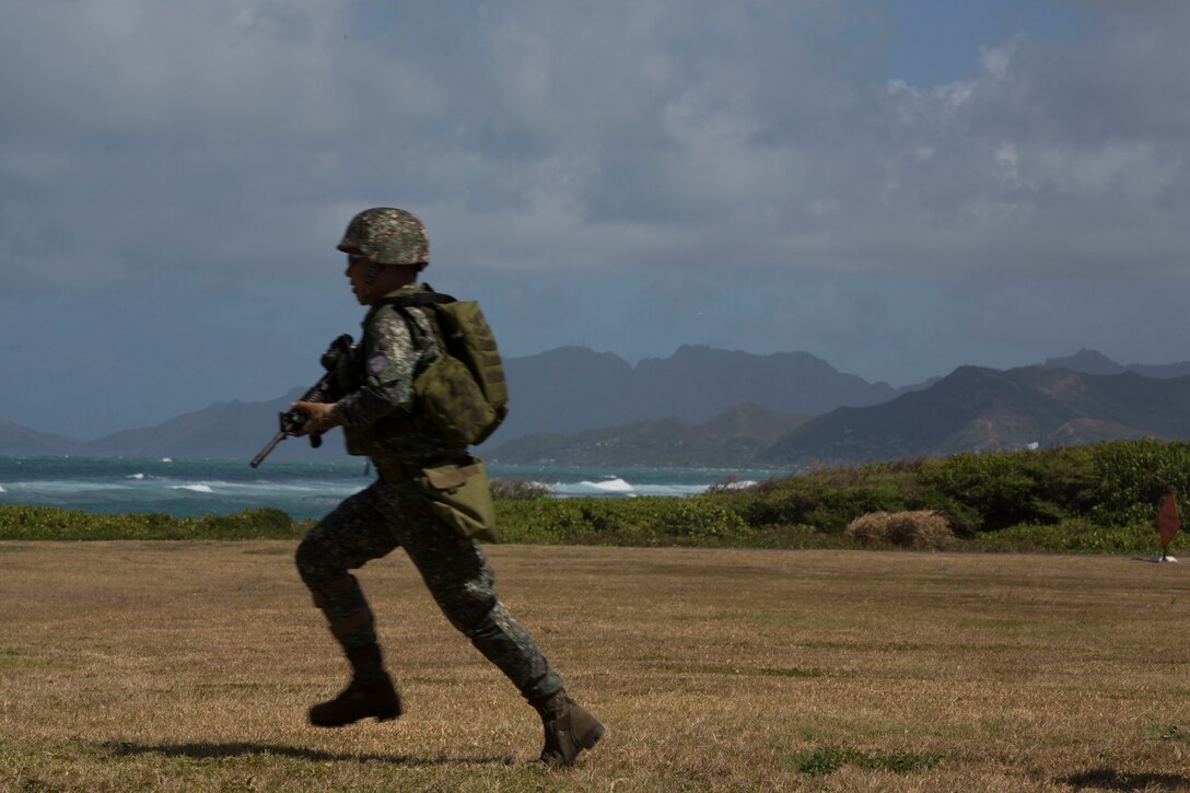 A Philippine marine maneuvers toward a landing zone during an air-assault rehearsal as part of Rim of the Pacific (RIMPAC) exercise on Marine Corps Base Hawaii July 6, 2018. RIMPAC provides high-value training for task-organized, highly-capable Marine Air-Ground Task Force and enhances the critical crisis response capability of U.S. Marines in the Pacific. Twenty-five nations, 46 ships, five submarines, about 200 aircraft and 25,000 personnel are participating in RIMPAC from June 27 to Aug. 2 in and around the Hawaiian Islands and Southern California.