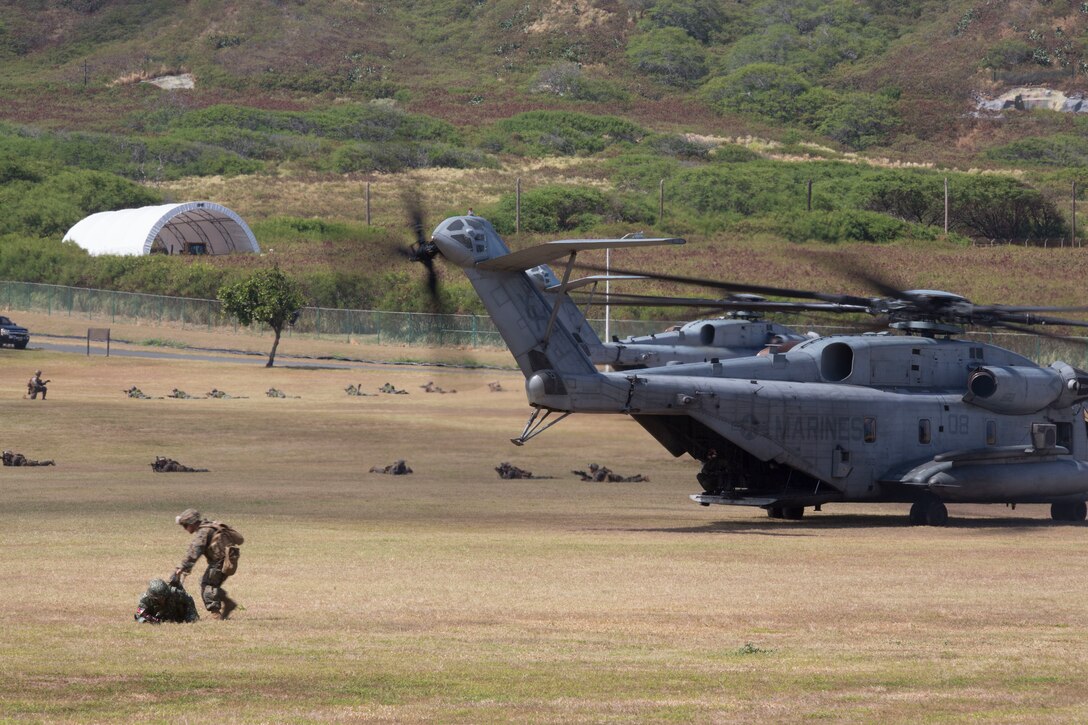 Philippine and U.S. Marines with Company A, 1st Battalion, 3rd Marine Regiment, post security around a CH-53 Super Stallion helicopter during an air-assault rehearsal as part of Rim of the Pacific (RIMPAC) exercise on Marine Corps Base Hawaii July 6, 2018. RIMPAC provides high-value training for task-organized, highly-capable Marine Air-Ground Task Force and enhances the critical crisis response capability of U.S. Marines in the Pacific. Twenty-five nations, 46 ships, five submarines, about 200 aircraft and 25,000 personnel are participating in RIMPAC from June 27 to Aug. 2 in and around the Hawaiian Islands and Southern California.