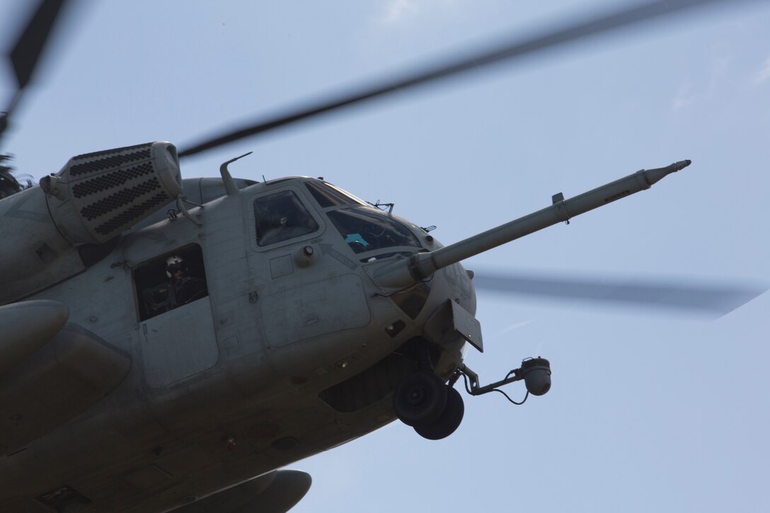 A U.S. Marine crew chief with Marine Heavy Helicopter Squadron 463, Marine Aircraft Group 24, 1st Marine Aircraft Wing, surveys the landing area for a CH-53E Super Stallion helicopter during an air-assault rehearsal as part of Rim of the Pacific (RIMPAC) exercise on Marine Corps Base Hawaii July 6, 2018. RIMPAC provides high-value training for task-organized, highly-capable Marine Air-Ground Task Force and enhances the critical crisis response capability of U.S. Marines in the Pacific. Twenty-five nations, 46 ships, five submarines, about 200 aircraft and 25,000 personnel are participating in RIMPAC from June 27 to Aug. 2 in and around the Hawaiian Islands and Southern California.