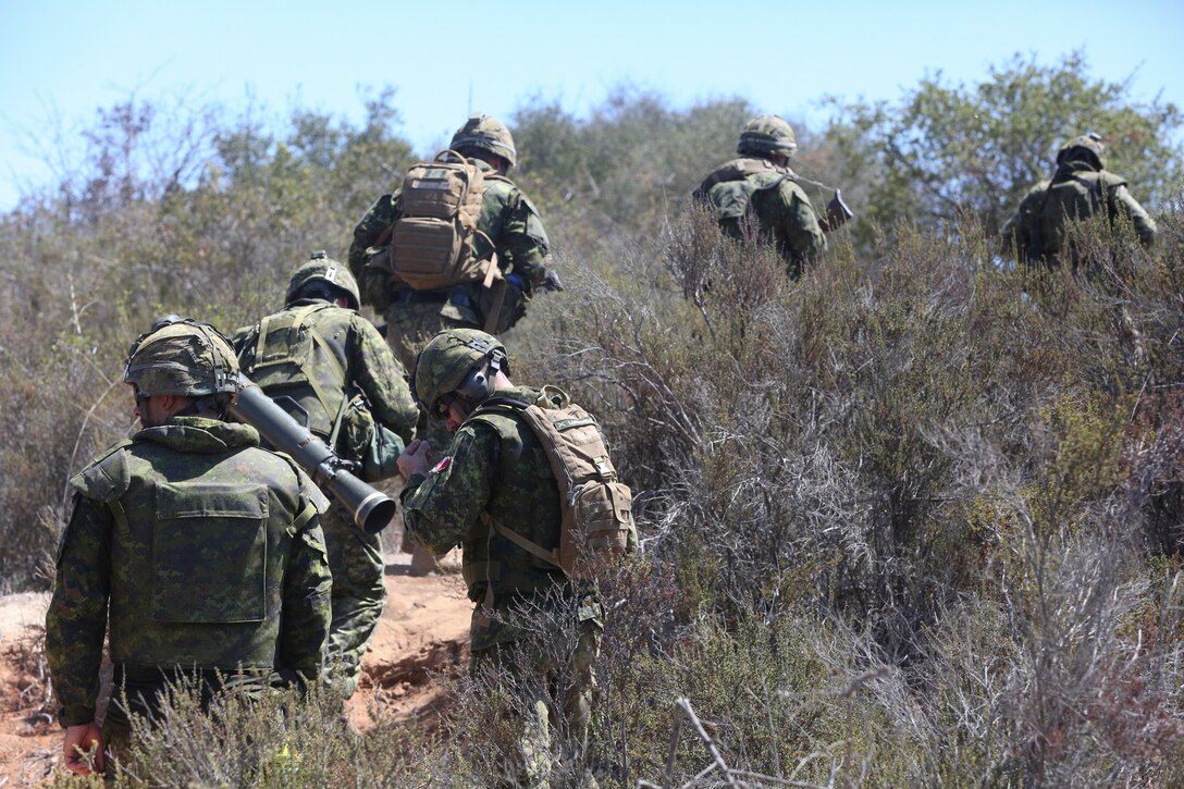 Canadian soldiers with the Royal 22e Régiment hike to a live-fire range during Rim of the Pacific (RIMPAC) exercise at Marine Corps Base Camp Pendleton, California, July 6, 2018. The training provided a dynamic environment, challenging leaders at the fire team and squad level by requiring the soldiers to react to pop-up targets in a tactical setting. RIMPAC provides high-value training for task-organized, highly-capable Marine Air-Ground Task Force and enhances the critical crisis response capability of U.S. Marines in the Pacific. Twenty-five nations, 46 ships, five submarines, about 200 aircraft and 25,000 personnel are participating in RIMPAC from June 27 to Aug. 2 in and around the Hawaiian Islands and Southern California.