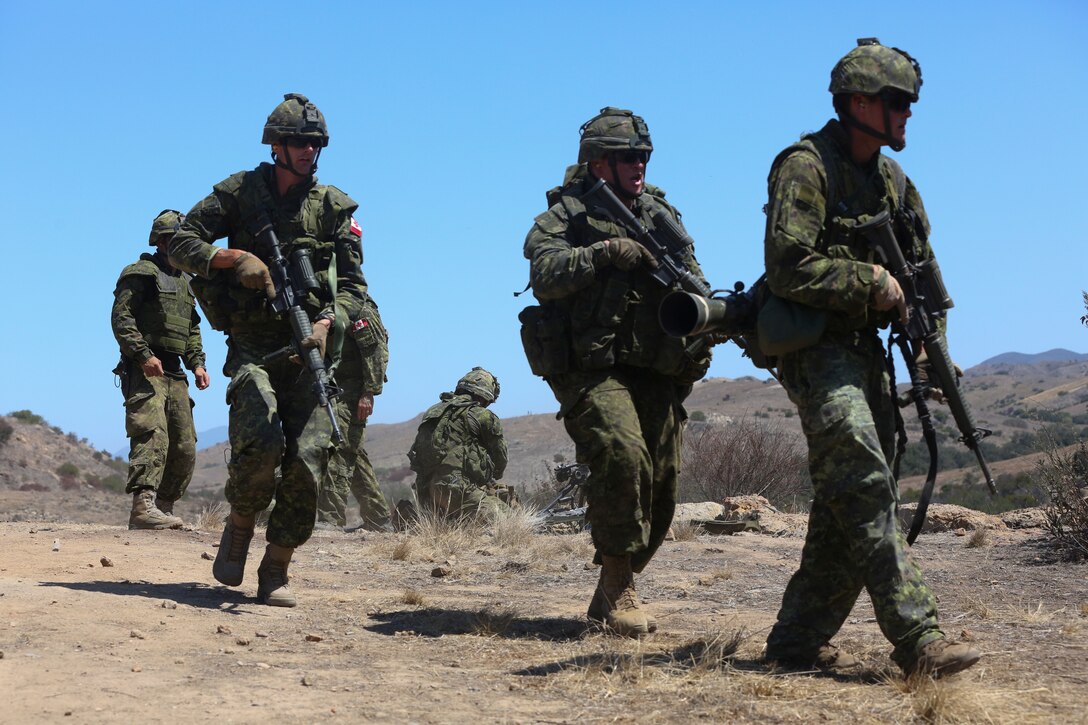 Canadian soldiers with the Royal 22e Régiment move to their next objective while conducting a live-fire range during Rim of the Pacific (RIMPAC) exercise at Marine Corps Base Camp Pendleton, California, July 6, 2018. The training provided a dynamic environment, challenging leaders at the fire team and squad level by requiring the soldiers to react to pop-up targets in a tactical setting. RIMPAC provides high-value training for task-organized, highly-capable Marine Air-Ground Task Force and enhances the critical crisis response capability of U.S. Marines in the Pacific. Twenty-five nations, 46 ships, five submarines, about 200 aircraft and 25,000 personnel are participating in RIMPAC from June 27 to Aug. 2 in and around the Hawaiian Islands and Southern California.