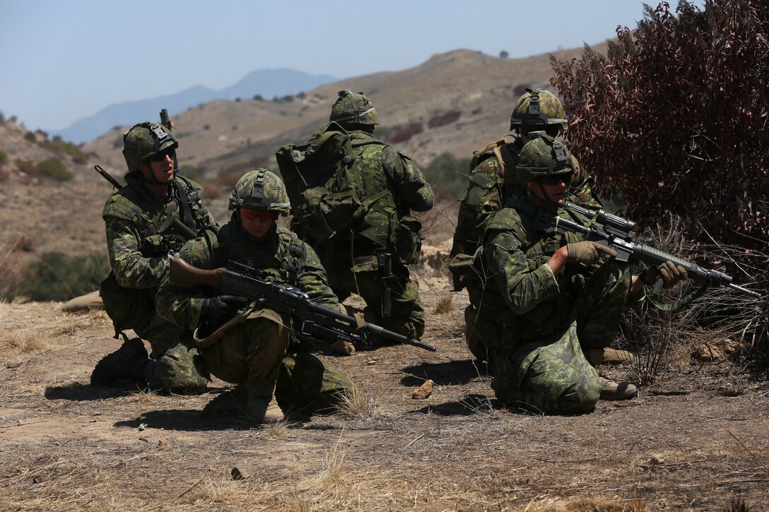 Canadian soldiers with Royal 22e Régiment take a defensive posture while conducting a live-fire range during Rim of the Pacific (RIMPAC) exercise at Marine Corps Base Camp Pendleton, California, July 6, 2018. The training provided a dynamic environment, challenging leaders at the fire team and squad level by requiring the soldiers to react to pop-up targets in a tactical setting. RIMPAC provides high-value training for task-organized, highly-capable Marine Air-Ground Task Force and enhances the critical crisis response capability of U.S. Marines in the Pacific. Twenty-five nations, 46 ships, five submarines, about 200 aircraft and 25,000 personnel are participating in RIMPAC from June 27 to Aug. 2 in and around the Hawaiian Islands and Southern California.