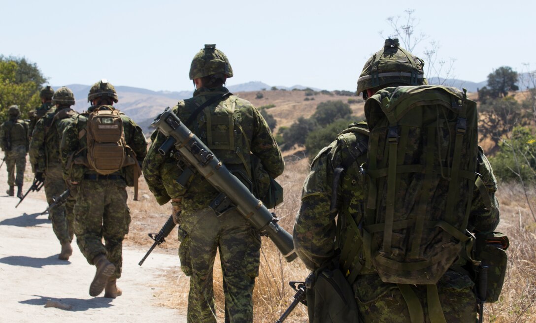 Canadian soldiers with the Royal 22e Régiment hike to a live-fire range during Rim of the Pacific (RIMPAC) exercise at Marine Corps Base Camp Pendleton, California, July 6, 2018. The training provided a dynamic environment, challenging leaders at the fire team and squad level by requiring the soldiers to react to pop-up targets in a tactical setting. RIMPAC provides high-value training for task-organized, highly-capable Marine Air-Ground Task Force and enhances the critical crisis response capability of U.S. Marines in the Pacific. Twenty-five nations, 46 ships, five submarines, about 200 aircraft and 25,000 personnel are participating in RIMPAC from June 27 to Aug. 2 in and around the Hawaiian Islands and Southern California.