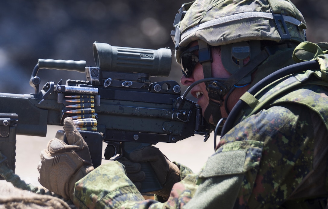 Canadian Army Sdt. Tondreau Blanchet, a machine gunner with the Royal 22e Régiment, fires his weapon at a live-fire range during Rim of the Pacific (RIMPAC) exercise at Marine Corps Base Camp Pendleton, California, July 6, 2018. The training provided a dynamic environment, challenging leaders at the fire team and squad level by requiring the soldiers to react to pop-up targets in a tactical setting. RIMPAC provides high-value training for task-organized, highly-capable Marine Air-Ground Task Force and enhances the critical crisis response capability of U.S. Marines in the Pacific. Twenty-five nations, 46 ships, five submarines, about 200 aircraft and 25,000 personnel are participating in RIMPAC from June 27 to Aug. 2 in and around the Hawaiian Islands and Southern California.