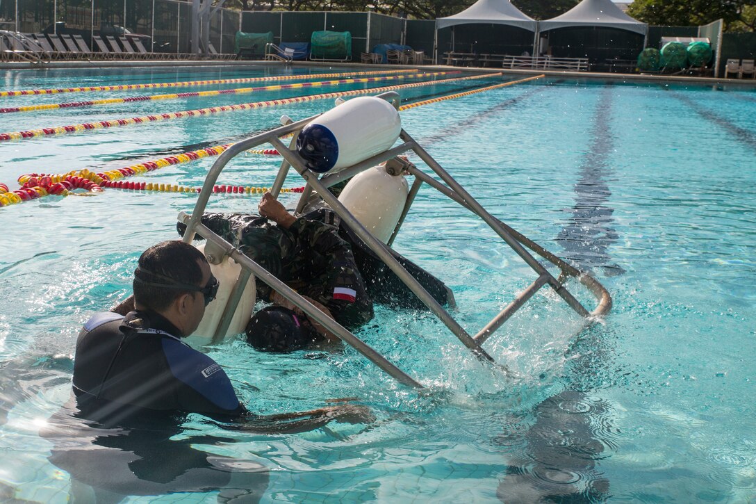 An Indonesian Marine gets flipped upside down simulating an aircraft water evacuation during shallow water egress training as part of Rim of the Pacific (RIMPAC) exercise at Marine Corps Base Hawaii July 5, 2018. RIMPAC provides high-value training for task-organized, highly-capable Marine Air-Ground Task Force and enhances the critical crisis response capability of U.S. Marines in the Pacific. Twenty-five nations, 46 ships, five submarines, about 200 aircraft and 25,000 personnel are participating in RIMPAC from June 27 to Aug. 2 in and around the Hawaiian Islands and Southern California.