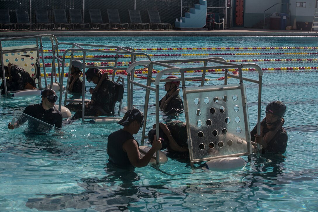 Indonesian Marines prepare to be flipped upside down simulating an aircraft water evacuation during shallow water egress training as part of Rim of the Pacific (RIMPAC) exercise at Marine Corps Base Hawaii July 5, 2018. RIMPAC provides high-value training for task-organized, highly-capable Marine Air-Ground Task Force and enhances the critical crisis response capability of U.S. Marines in the Pacific. Twenty-five nations, 46 ships, five submarines, about 200 aircraft and 25,000 personnel are participating in RIMPAC from June 27 to Aug. 2 in and around the Hawaiian Islands and Southern California.