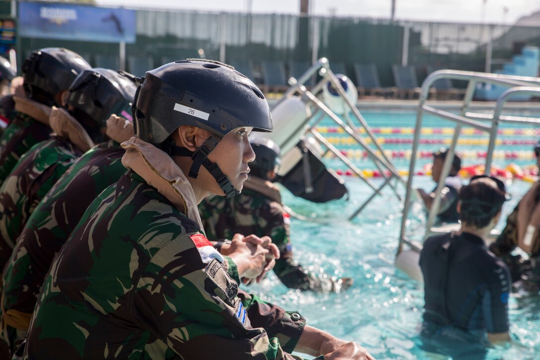 Indonesian Marines standby to enter the pool during shallow water egress training as part of Rim of the Pacific (RIMPAC) exercise at Marine Corps Base Hawaii July 5, 2018. RIMPAC provides high-value training for task-organized, highly-capable Marine Air-Ground Task Force and enhances the critical crisis response capability of U.S. Marines in the Pacific. Twenty-five nations, 46 ships, five submarines, about 200 aircraft and 25,000 personnel are participating in RIMPAC from June 27 to Aug. 2 in and around the Hawaiian Islands and Southern California.