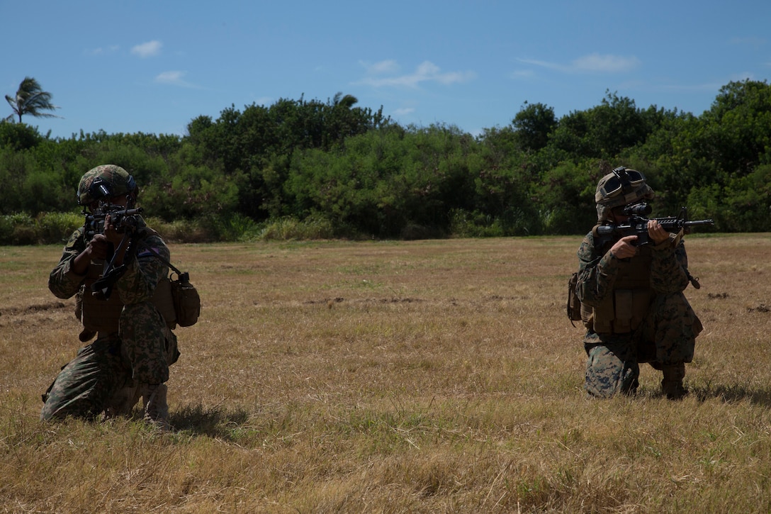 U.S. Marines with Company C, 1st Battalion, 3rd Marine Regiment, and Malaysian soldiers post security during assault amphibious vehicle familiarization training as part of Rim of the Pacific (RIMPAC) exercise on Marine Corps Base Hawaii July 5, 2018. RIMPAC provides high-value training for task-organized, highly-capable Marine Air-Ground Task Force and enhances the critical crisis response capability of U.S. Marines in the Pacific. Twenty-five nations, 46 ships, five submarines, about 200 aircraft and 25,000 personnel are participating in RIMPAC from June 27 to Aug. 2 in and around the Hawaiian Islands and Southern California.