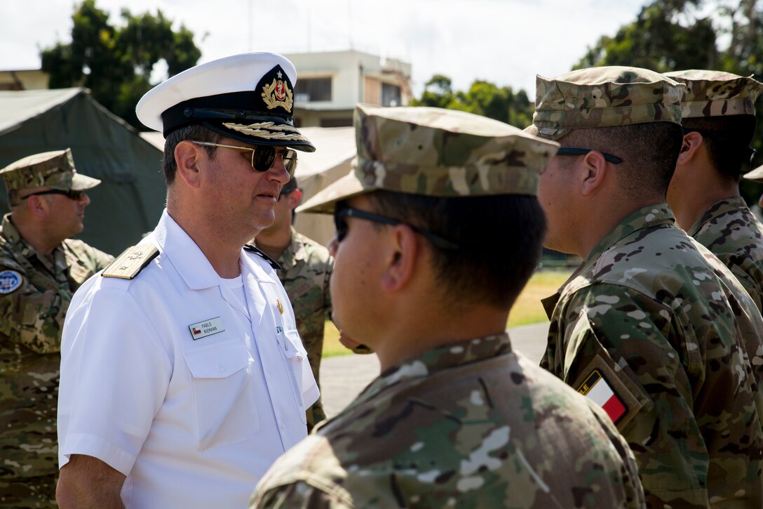 Chilean Navy Commodore Pablo Niemann, Combined Forces Maritime Component Commander for Rim of the Pacific (RIMPAC) exercise, speaks with Chilean Marines at Marine Corps Base Hawaii July 6, 2018. Twenty-five nations, 46 ships, five submarines, about 200 aircraft and 25,000 personnel are participating in RIMPAC from June 27 to Aug. 2 in and around the Hawaiian Islands and Southern California. The world’s largest international maritime exercise, RIMPAC provides a unique training opportunity while fostering and sustaining cooperative relationships among participants critical to ensuring the safety of sea lanes and security of the world’s oceans.