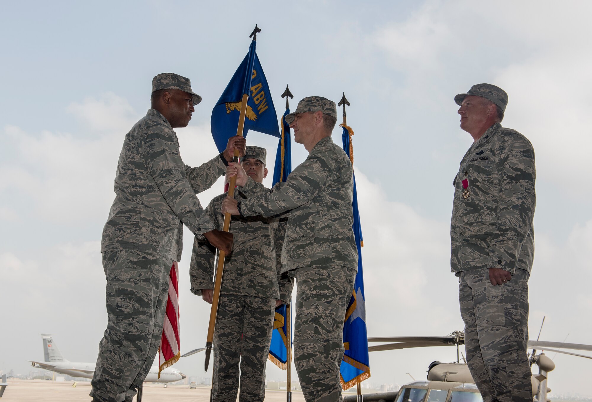 U.S. Air Force Lt. Gen. Richard M. Clark, 3rd Air Force commander, passes a guide-on to Col. Britt Hurst during a change of command ceremony at Incirlik Air Base, Turkey, July 10, 2018.