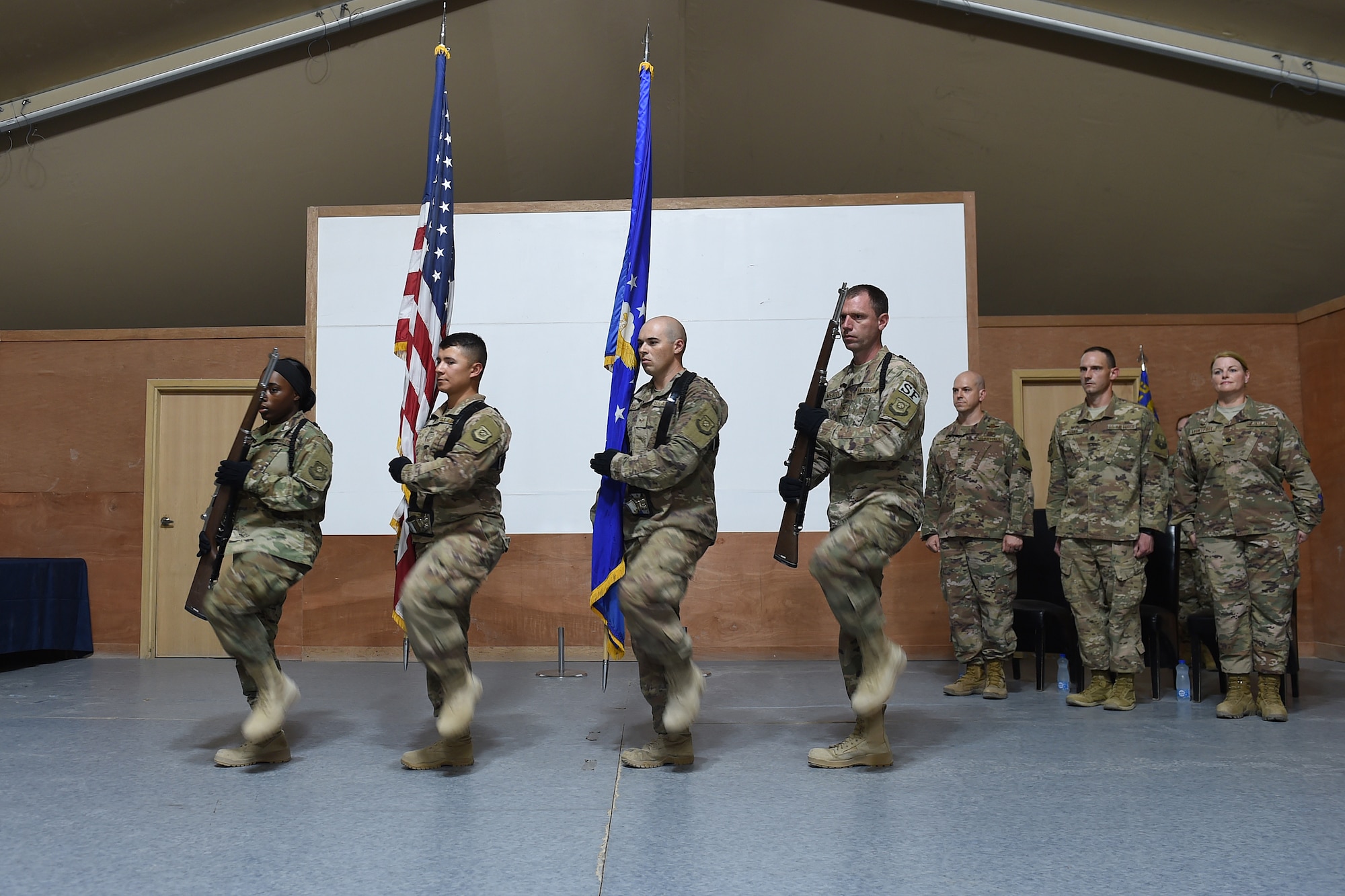 two airman hold the American and U.S. Air Force flag