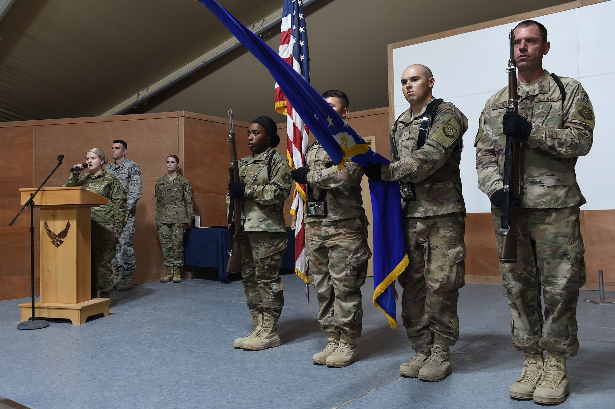 two airman hold the American and Air Force flag