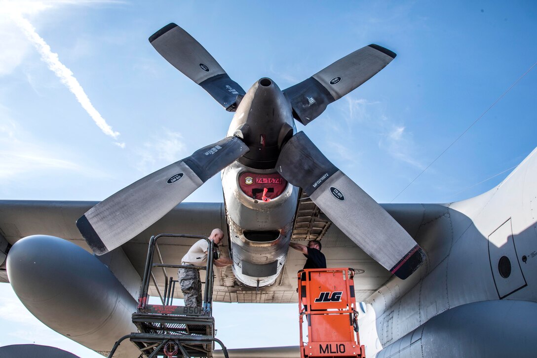 Airmen perform maintenance on a C-130H Hercules engine.