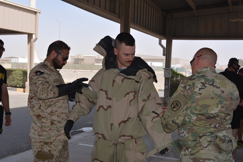 Capt. Abdul-Aziz Hamad Al-Muteri (left), with the Kuwait Minister of Defense Weapons of Mass Destruction Defense Directorate and Lt. Col. Dr. Donald Kimbler (right), deputy chief, Chemical Casualty Care Division, U.S. Army Medical Research Institute of Chemical Defense (USAMRICD) test a simulated casualty for exposure to nerve agent during a training event June 27, 2018.