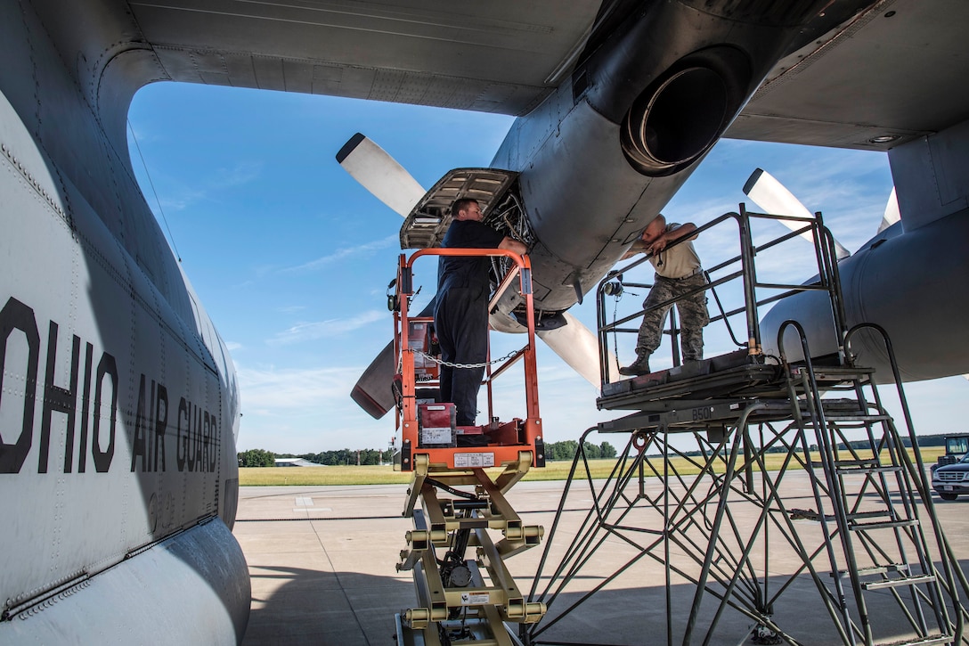 Airmen perform maintenance on a C-130H Hercules engine.
