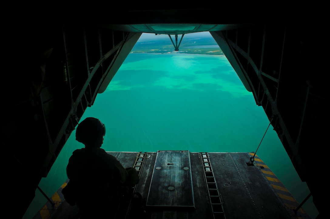 U.S. Marine Staff Sgt. David B. Scranton, a CH-53E Super Stallion helicopter crew chief with Special Purpose Marine Air-Ground Task Force - Southern Command, scans the water below his aircraft during a flight near the coast of Belize, July 8, 2018. The SPMAGTF-SC aviation detachment conducted this exercise to prepare for transporting Marines from ship to shore in the event of a natural disaster or humanitarian operation. The Marines and sailors of SPMAGTF-SC are conducting security cooperation training and engineering projects alongside partner nation military forces in Central and South America. The unit is also on standby to provide humanitarian assistance and disaster relief in the event of a hurricane or other emergency in the region.