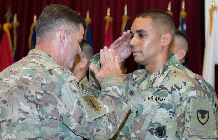 Sgt. 1st Class Jonah Even, a maintenance management noncommissioned officer assigned to the 401st Army Field Support Battalion-Qatar, salutes U.S. Army Maj. Gen. "Donnie" B. Walker, commanding general of the 1st Theater Sustainment Command, after being presented with the Army Commendation Medal at the Sergeant Audie Murphy Club induction ceremony held at Camp Arifjan, Kuwait, July 7, 2018. The ceremony was held to induct Even and Sgt. 1st Class Roberto Castaneda, a platoon sergeant with the 202nd Military Police Company attached to U.S. Army Central Personnel Security Detail as the noncommissioned officer in charge, into the SAMC.