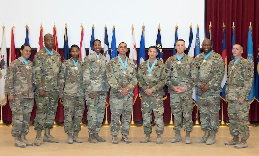 Members of the Camp Arifjan Sergeant Audie Murphy Club gather after the conclusion of a SAMC induction ceremony at Camp Arifjan, Kuwait, July 7, 2018. The SAMC is a means of recognizing NCOs who have contributed significantly to the development of a professional NCO Corps and a combat ready Army.