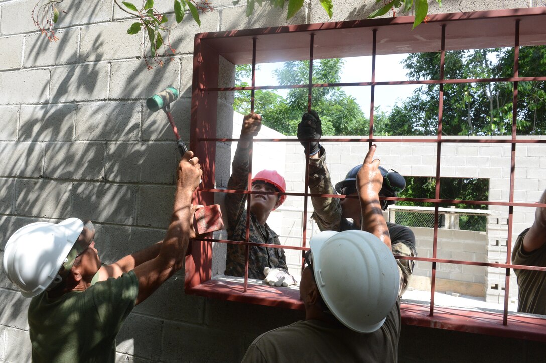 Soldiers build a school addition in El Salvador.