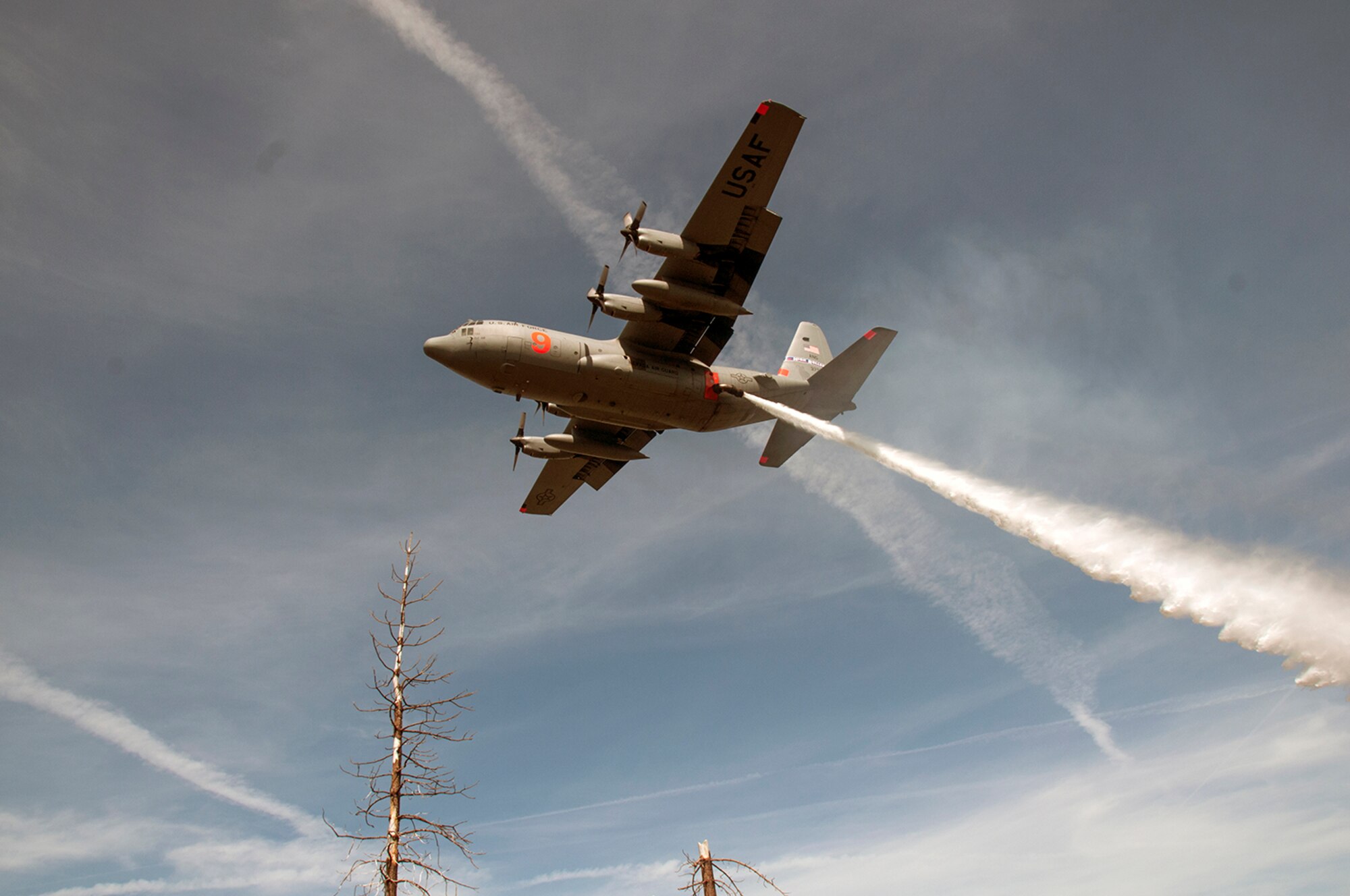 SACRAMENTO, Calif. - Aircrew from the 152nd Airlift Wing, Reno, Nevada, perform water training drops using the U.S.D.A Forest Service's Modular Airborne Fire Fighting System in the Sierra mountain range east of Sacramento April 24. The 152nd Airlift Wing achieved their training objectives for certification at McClellan Reload Base last month during their annual training and are currently assisting with wildfire fighting efforts in Colorado. (Photo by 2nd Lt. Emerson Marcus)