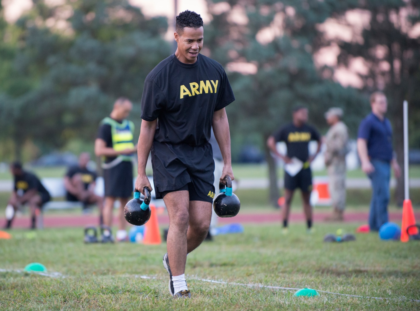 A Soldier carries two 40-pound kettlebell weights during a pilot for the Army Combat Fitness Test, a six-event assessment designed to reduce injuries and replace the current Army Physical Fitness Test.