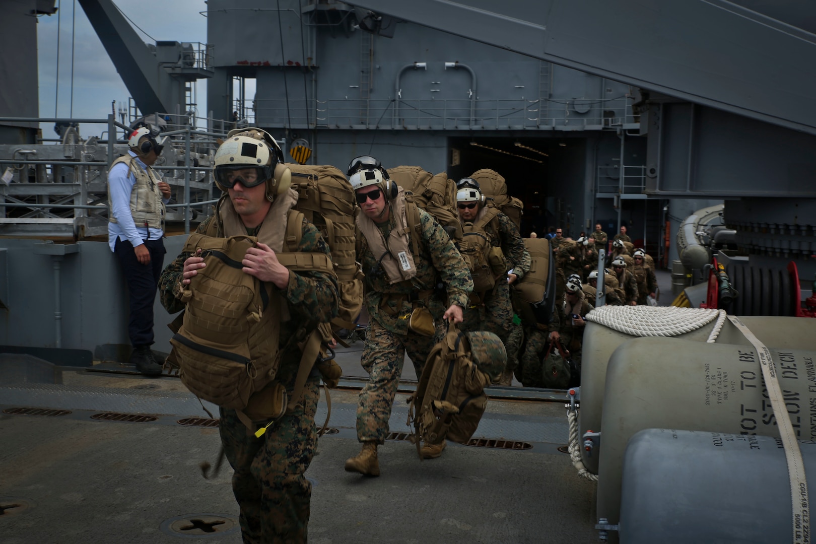 U.S. Marines board a helicopter on USS Gunston Hall.