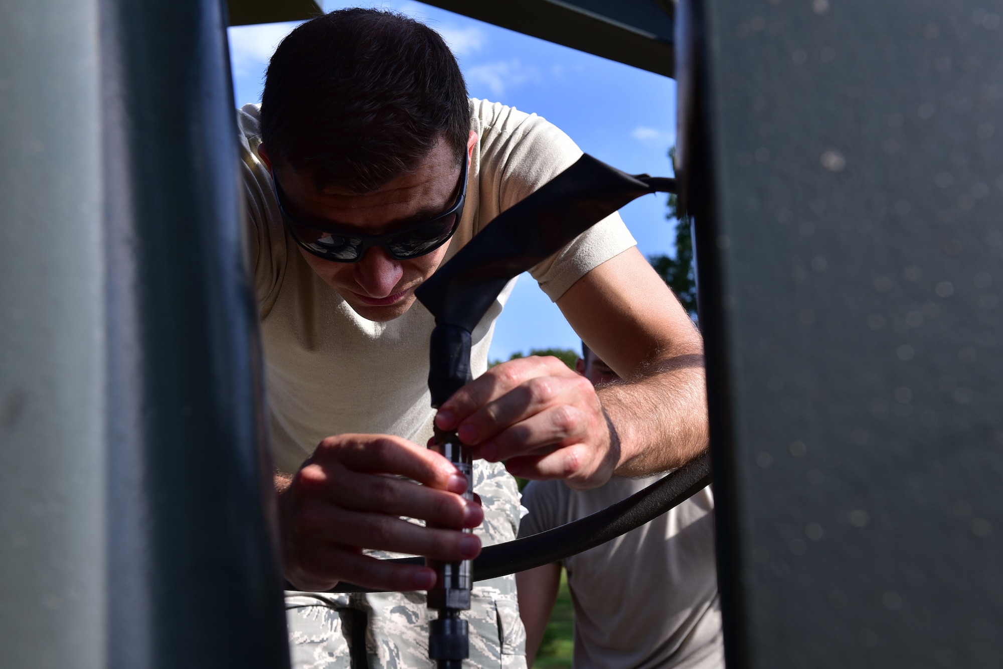 Man connects calibration tool with engine test cell.