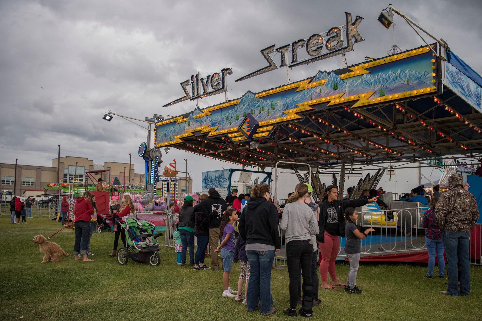 Participants wait in line for an amusement ride during the 3rd annual Summer Fest hosted by the 673d Force Support Squadron at Joint Base Elmendorf-Richardson, Alaska, July 8, 2018. The event was open to anyone with base access and offered free activities such as carnival rides, a petting zoo, face painting, a bungee trampoline, and carnival games.