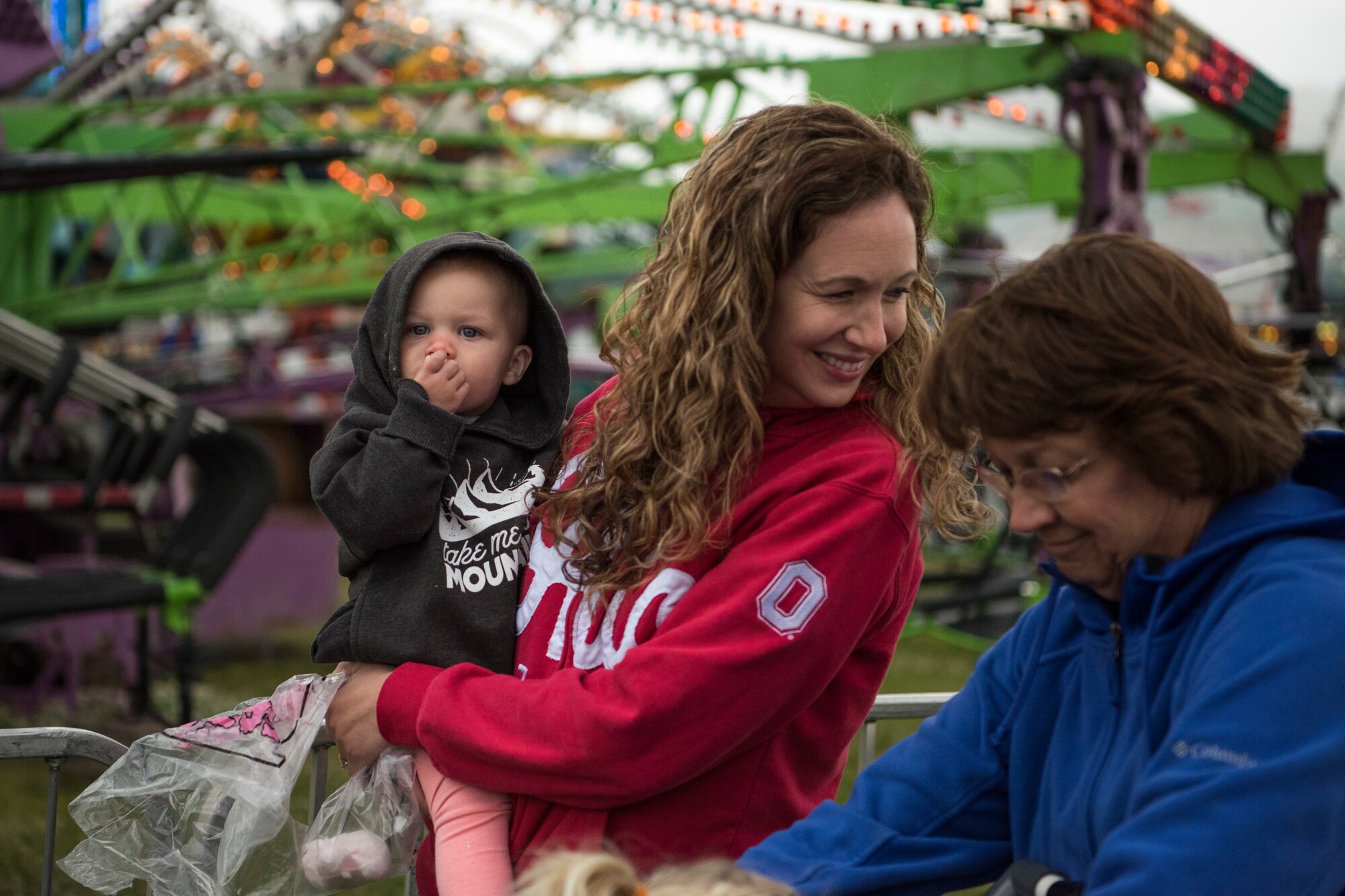 Hailey, 1, is held by her aunt, Jama Singh, as she eats cotton candy during the 3rd annual Summer Fest hosted by the 673d Force Support Squadron at Joint Base Elmendorf-Richardson, Alaska, July 8, 2018. The event was open to anyone with base access and offered free activities such as carnival rides, a petting zoo, face painting, a bungee trampoline, and carnival games.