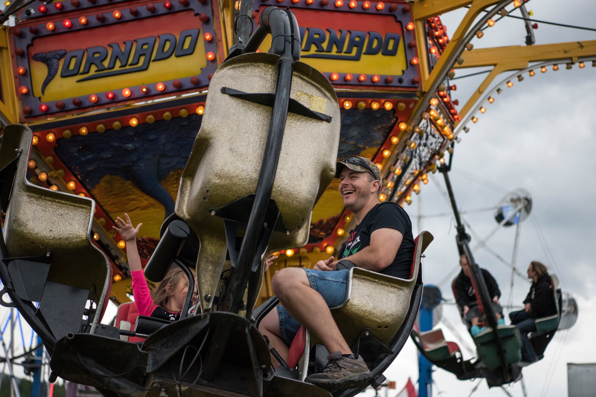 Participants ride the “Tornado” during the 3rd annual Summer Fest hosted by the 673d Force Support Squadron at Joint Base Elmendorf-Richardson, Alaska, July 8, 2018. The event was open to anyone with base access and offered free activities such as carnival rides, a petting zoo, face painting, a bungee trampoline, and carnival games.