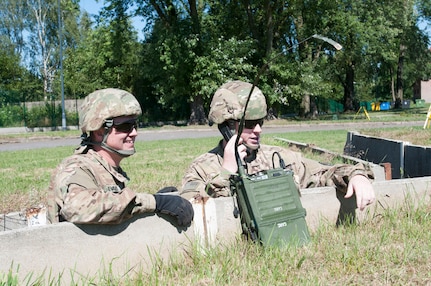 U.S. Army Spc. Jeffery Evans and Pfc. John Collins, both assigned to Company B, 151st Expeditionary Signal Battalion, confirm message transmission on a high frequency radio via a field-expedient antenna created from internet cable and plastic spoons during an HF radio class taught by Staff Sgt. David Nelson, a signal support systems specialist assigned to 218th MEB in support of Resolute Castle 2018.