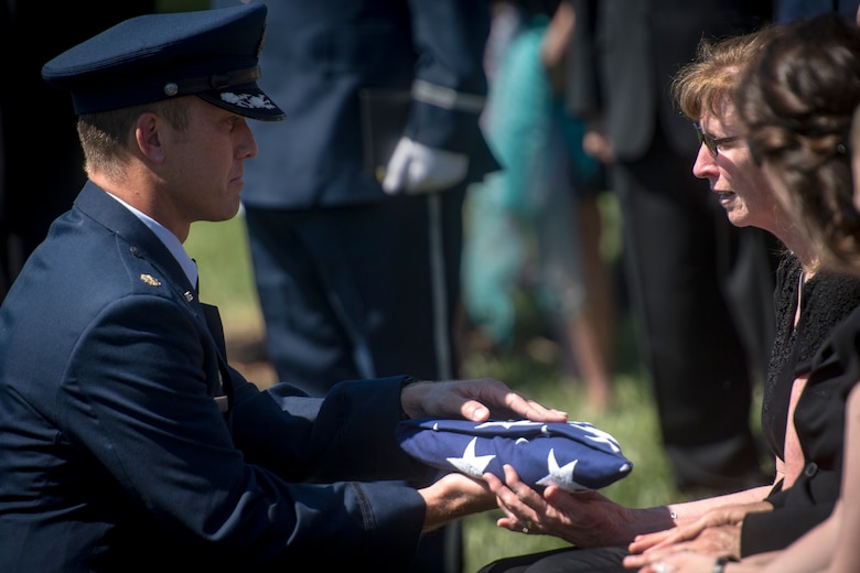 Maj. Jason Egger, 38th Rescue Squadron commander, presents a folded flag to the family of Capt. Mark Weber during his funeral service, July 9, 2018, at Arlington National Cemetery, Va. Weber, a 38th RQS combat rescue officer and Texas native, was killed in an HH-60G Pave Hawk crash in Anbar Province, Iraq, March 15. Friends, family, and Guardian Angel Airmen traveled from across the U.S. to attend the ceremony and pay their final respects. (U.S. Air Force photo by Staff Sgt. Ryan Callaghan)