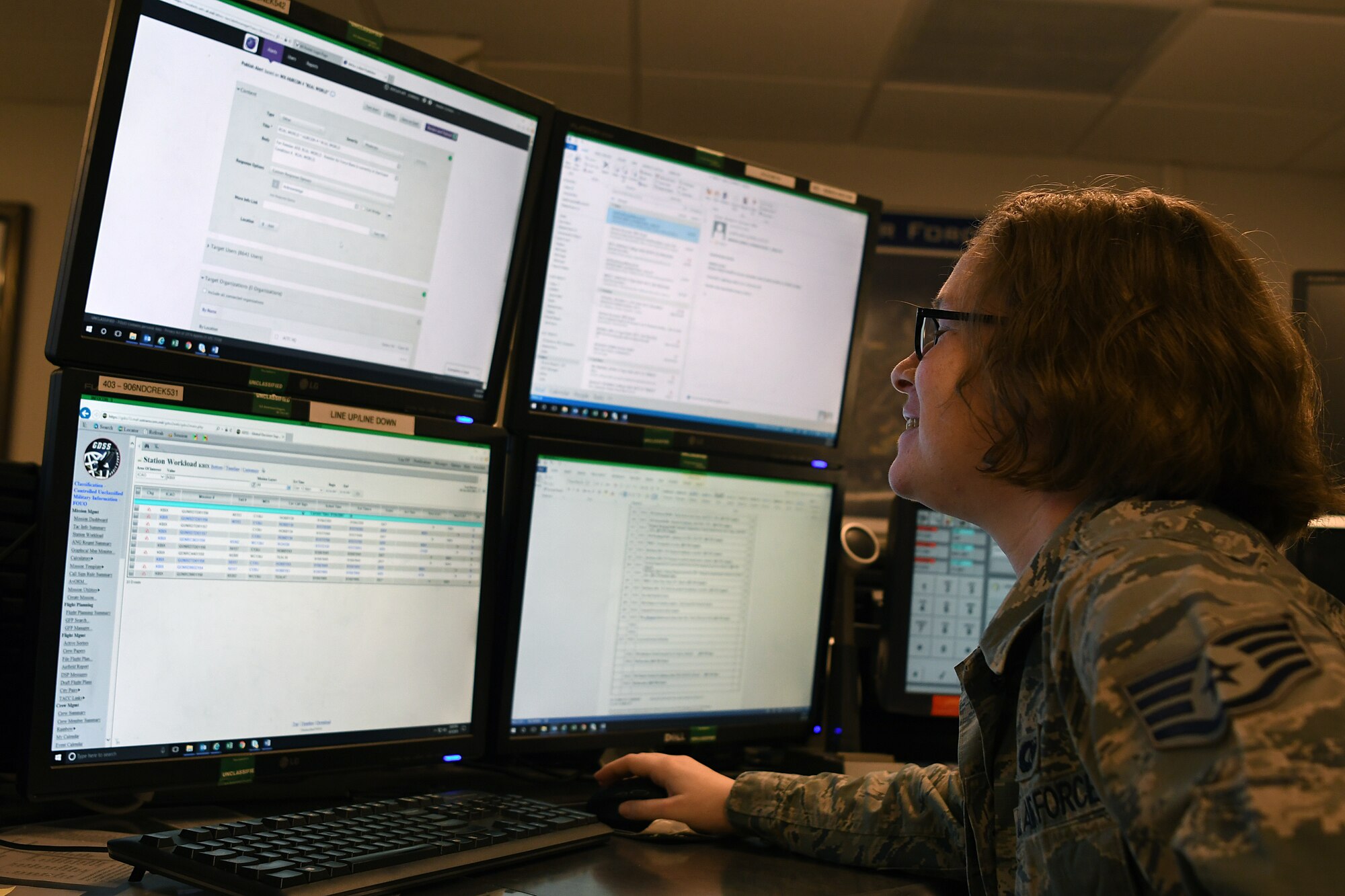 U.S. Air Force Staff Sgt. Kaylee Sprout, 81st Training Wing emergency action controller NCO in charge of systems, looks over emergency notification systems in the command post at Keesler Air Force Base, Mississippi, June 5, 2018. Emergency action controllers are responsible for receiving and disseminating information during emergencies. (U.S. Air Force photo by Airman 1st Class Suzie Plotnikov)