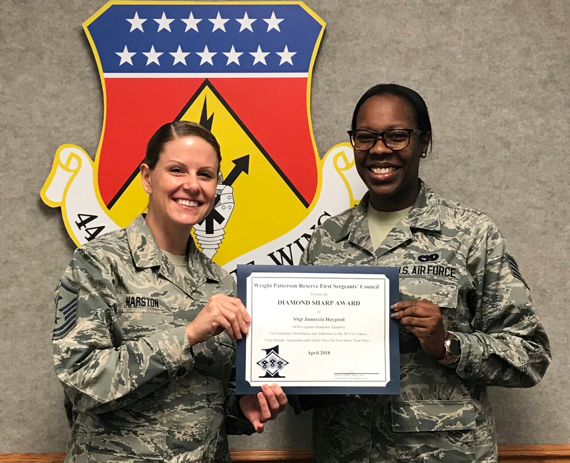 Master Sgt. Lauren Harston, 445th Logistics Readiness Squadron first sergeant, presents the April 2018 Diamond Sharp Award to Staff Sgt. Jameccia Haygood, 445th Logistics Readiness Squadron, during the June 9, 2018 unit training assembly. The award is for exemplary performance, adherence to the Air Force Core Values, attitude, appearance and ability.