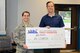 Kraig Hanson, Director of Hill Air Force Base Family Foundation, hands a donation check for the Airman Recreation Center to Airman 1st Class Allison West, who is President of the Hill First Four. The recreation center is in
the midst of a renovation in need of new floors and furniture for the Airmen. The Foundation is an organization on base that coordinates fundraisers benefiting Hill Airmen, civilians, and their families. Their next big fundraiser is their Roundup dinner and will be held Oct. 4. For more information see www.HillAFBFamilyFoundation.org (U.S. Air Force photo
by Cynthia Griggs)