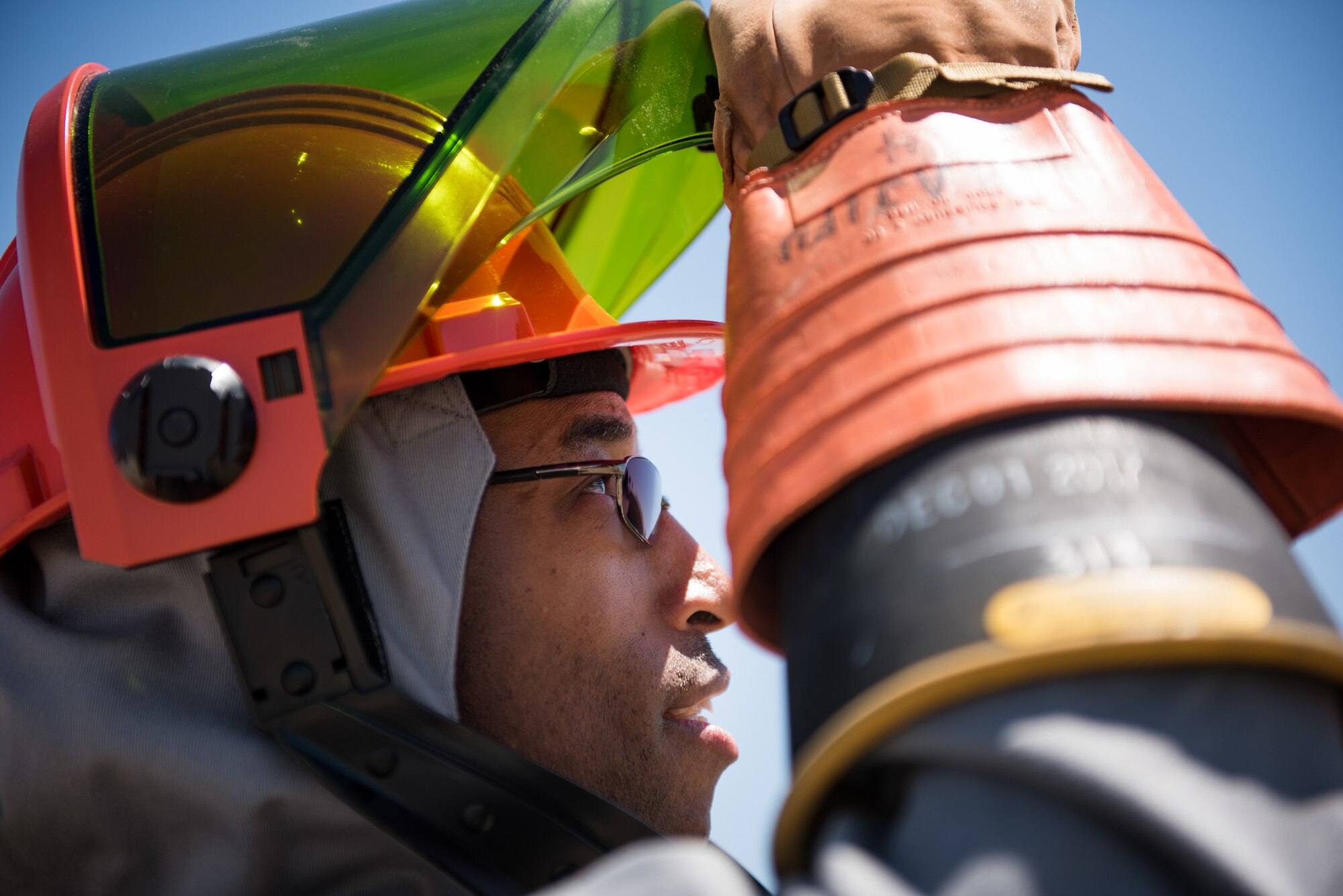 Staff Sgt. Alvin Walker, an electrical systems craftsman with the 137th Special Operations Civil Engineering Squadron (137th SOCES), Oklahoma City, lifts the visor on his hood of an arc flash suit during deployment readiness training at March Air Reserve Base in Moreno Valley, California, June 27, 2018. The 137th SOCES members train at a regional training site every three years as a part of this deployment readiness training. (U.S. Air National Guard photo by Staff Sgt. Brigette Waltermire)