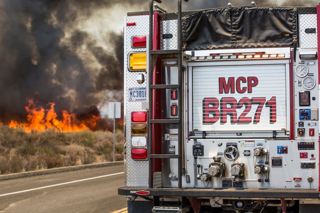 Firefighters with the Camp Pendleton Fire Department combat a fire in the Santa Margarita/De Luz Housing area on Marine Corps Base Camp Pendleton, California, July 6, 2018.(U.S. Marine Corps photo by Cpl. Dylan Chagnon)